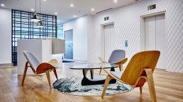 A modern office lobby area with designer interior features
