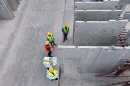 An architect and engineers discuss a construction project on-site